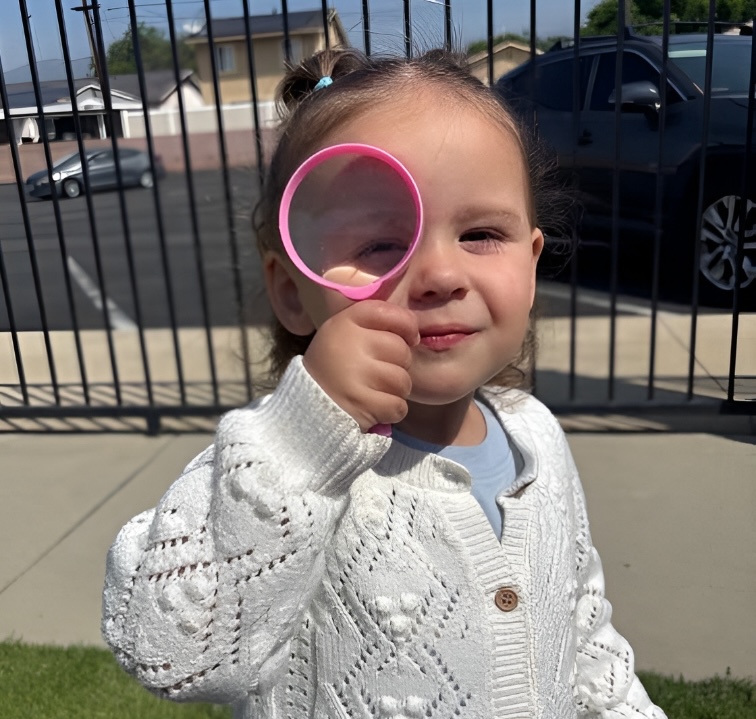 Child exploring with magnifying glass